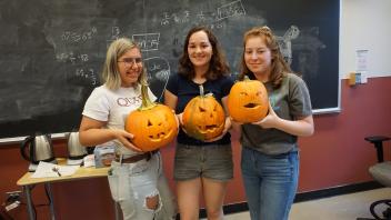 Tara, Sam, and Noa posing with their pumpkins!
