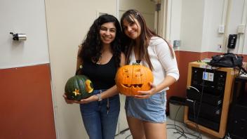 Sarah and her friend showing off their pumpkins!