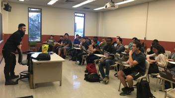 Members listening to a company representative speak